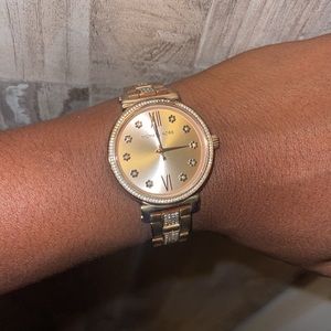 Women’s rose gold Michael Kors watch.